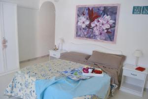 a bedroom with a bed with a tray of food on it at Maridea - Insvla in Ponza