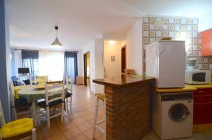 a kitchen and living room with a table and a microwave at MEDES PARK I 2-7 in L'Estartit +4 photos