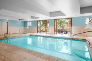 a large swimming pool with blue water in a building at Holiday Inn Express Hotel & Suites Ontario, an IHG Hotel in Ontario