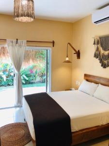 Postel nebo postele na pokoji v ubytování Hotel CasaBakal - A pie de Laguna - Bacalar