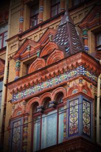 a building with ornate windows on the side of it at Никонов отель in Saint Petersburg