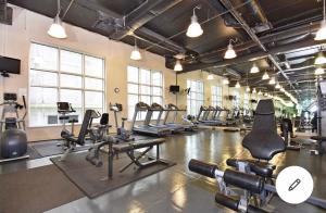 a gym with several treadmills and cardio machines at Vancouver Downtown Central 1 bedroom Condo in Vancouver