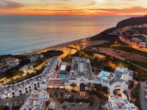 an aerial view of a resort and the ocean at sunset at Belmar Spa & Beach Resort in Lagos