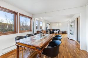 a dining room with a wooden table and chairs at Goldin in Kautokeino