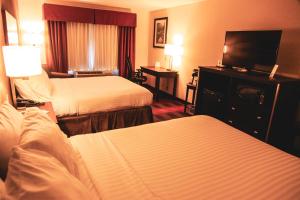 a hotel room with two beds and a flat screen tv at Holiday Inn Express & Suites Cumberland - La Vale by IHG in La Vale