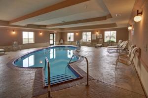 a pool in a hotel room with stairs around it at Holiday Inn Express Hotel and Suites Altus, an IHG Hotel in Altus