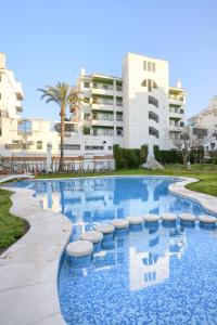 a large swimming pool in front of a building at Apartamentos BCL Playa Albir in Albir