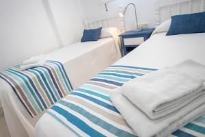Una cama o camas en una habitación de Apartamentos BCL Playa Albir