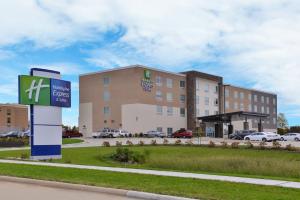 a hotel building with a sign in front of it at Holiday Inn Express & Suites - Marshalltown, an IHG Hotel in Marshalltown