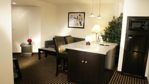 a hotel room with a table and chairs in a room at Holiday Inn Express Hollywood Walk of Fame by IHG in Los Angeles