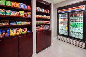 a store aisle with a refrigerator filled with food at Holiday Inn Express Hollywood Walk of Fame by IHG in Los Angeles