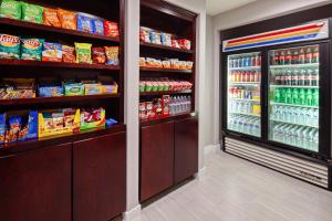 a store aisle with a refrigerator filled with food at Holiday Inn Express Hollywood Walk of Fame, an IHG Hotel in Los Angeles