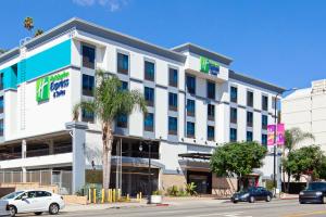 an office building with cars parked in front of it at Holiday Inn Express Hollywood Walk of Fame by IHG in Los Angeles
