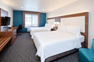 a hotel room with two beds and a flat screen tv at Holiday Inn Express Hollywood Walk of Fame by IHG in Los Angeles