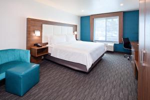 a hotel room with a bed and a chair at Holiday Inn Express Hollywood Walk of Fame by IHG in Los Angeles