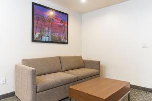 a living room with a couch and a table at Holiday Inn Express Hollywood Walk of Fame by IHG in Los Angeles