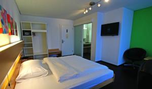 A bed or beds in a room at Hotel Stalden