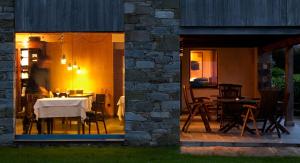 a dining room with a table and chairs on a patio at Hotel Torre De Villademoros in Luarca