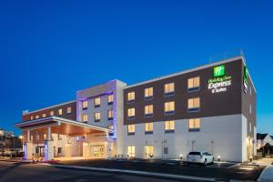a hotel building with a car parked in front of it at Holiday Inn Express & Suites - Medford by IHG in Medford