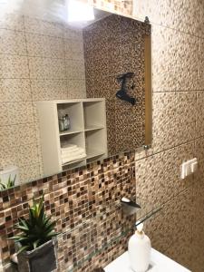 a bathroom with a mirror and a sink at Sea View Apartment in Klaipėda in Klaipėda +21 photos