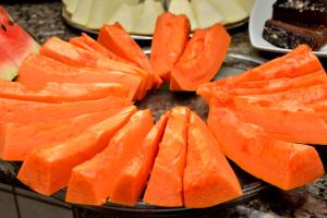 a pile of carrots on a plate with other foods at Carvalho's Hotel in Palmas