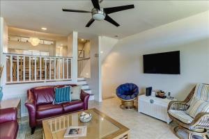 a living room with a couch and a tv at Sandpiper in Fernandina Beach