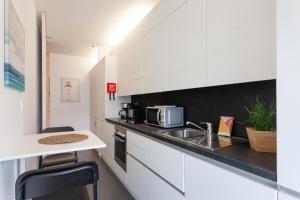 uma cozinha com um lavatório e um micro-ondas em FLH Expo Modern Flat with Balcony em Lisboa