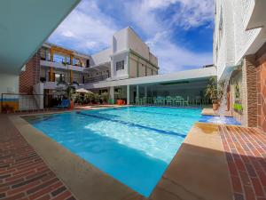 a swimming pool in the middle of a building at Hotel Victoria Plaza Millenium in Cúcuta