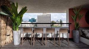 a balcony with chairs and a view of a city at Penthouse 3BR near Rothschild bd by HolyGuest in Tel Aviv +26 photos
