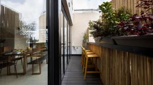 a balcony with a table and chairs in a building at Penthouse 3BR near Rothschild bd by HolyGuest in Tel Aviv