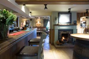 a kitchen with a stove and a fire place at Red Lion Inn in Little Budworth