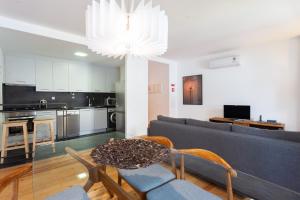 a living room with a couch and a table at FLH Liberdade Contemporary Flat in Lisbon