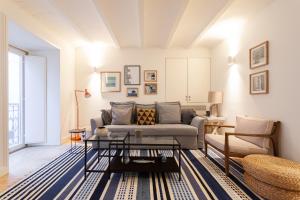 a living room with a couch and a table at FLH Bairro Alto Elegant Apartment in Lisbon
