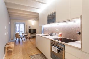 a kitchen with white cabinets and a counter top at FLH Bairro Alto Elegant Apartment in Lisbon