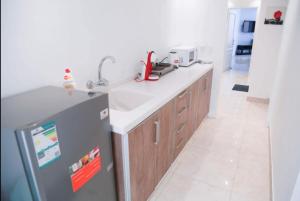 a kitchen with a sink and a refrigerator at Happiness Chalet 512 in Jeddah