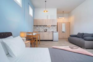a living room and kitchen with a bed and a couch at Villa Remetzo in Skala Potamias