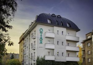 a building with a dome on top of it at Hotel Otar in Prague