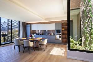 an open kitchen and dining room with a table and chairs at Cassa Luxury Homes in Bogotá