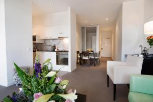 a living room with a kitchen and a dining room at Adara Hotel Richmond in Melbourne