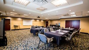 a conference room with tables and chairs and a podium at Holiday Inn Express Hotel & Suites Pampa, an IHG Hotel in Pampa