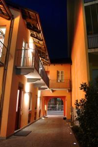 an empty hallway of an apartment building at night at Locanda Cortiletto d'Alba in Alba