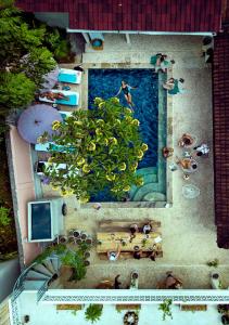 an overhead view of a swimming pool with people in it at The Chillhouse Canggu by BVR Bali Holiday Rentals in Canggu