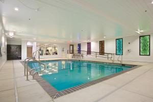a large swimming pool with blue water in a building at Holiday Inn Express Hotel & Suites - Paso Robles by IHG in Paso Robles