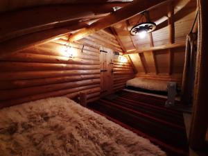 a room with a bed in a wooden cabin at Вила Орцево Vila Ortsevo in Ortsevo