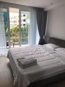 a bedroom with a large bed with towels on it at Centara Avenue a4,Near WALKING STREET,freePOOL,GYM in Pattaya