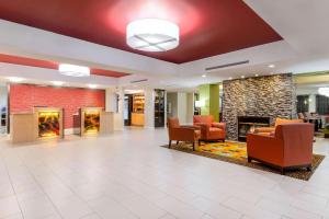 a lobby of a hospital with chairs and a fireplace at La Quinta Inn & Suites - New River Gorge National Park in Summersville +37 photos