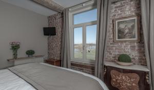 Voodi või voodid majutusasutuse Auberge l'Entrecôte toas