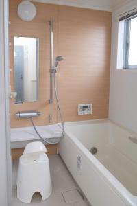 a bathroom with a shower and a toilet and a tub at Kumamoto - Apartment / Vacation STAY 76520 in Kumamoto