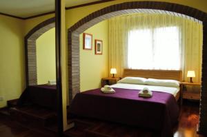 a bedroom with a large bed and a window at Villa Martina in Tossa de Mar