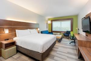 a hotel room with a bed and a flat screen tv at Holiday Inn Express & Suites - Moreno Valley - Riverside by IHG in Moreno Valley
